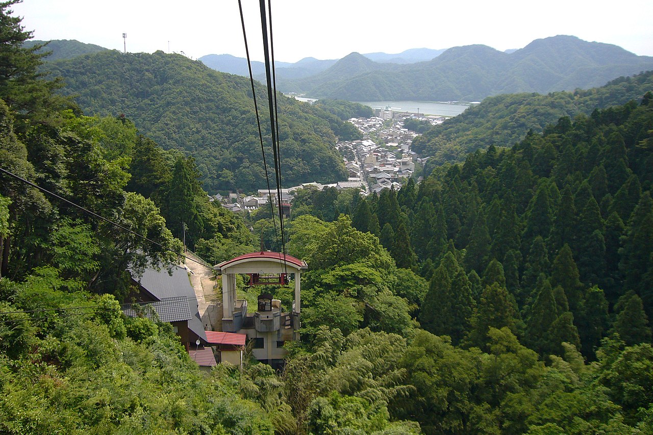Kinosaki Ropeway - Cable car gliding over the forested mountain above town