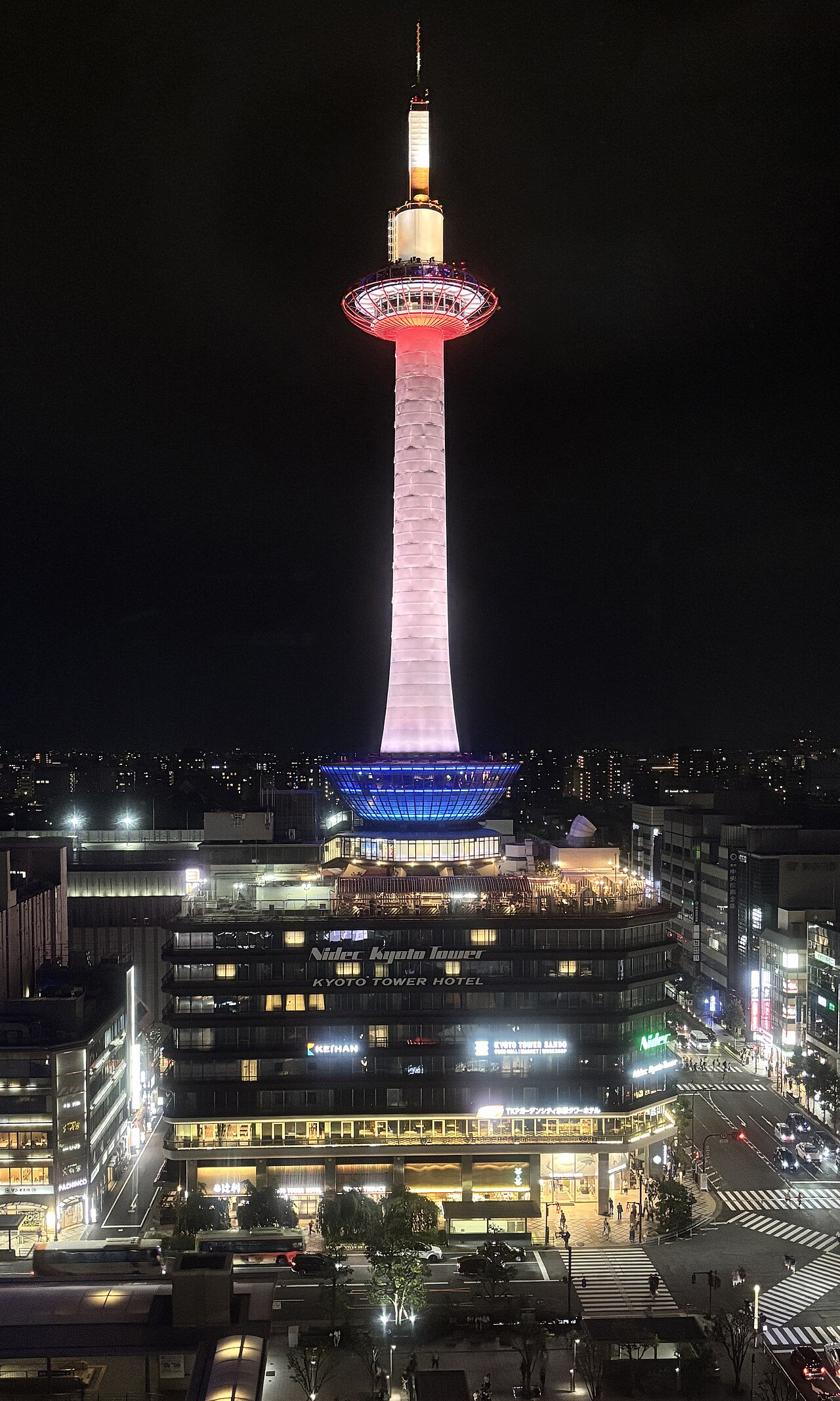 Kyoto Tower - Kyoto Tower lit up at night opposite Kyoto Station